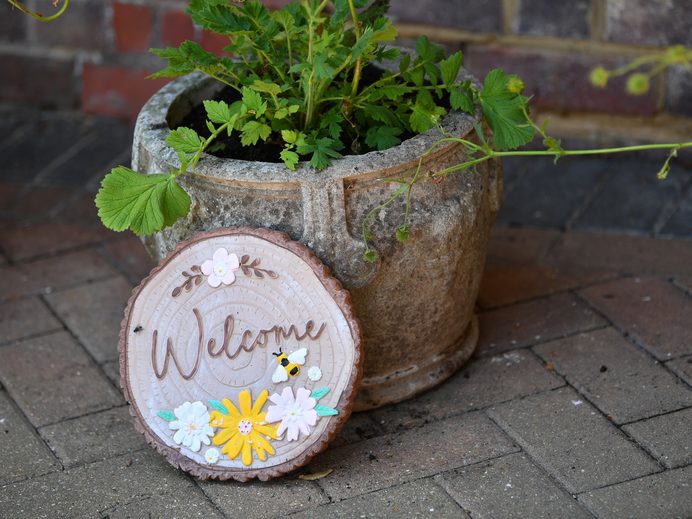 Welcome sign beside a planter at Friars Lodge